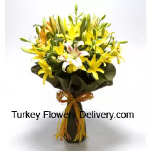 Iso kimppu keltaisia ja valkoisia liljoja sesongin täyteaineilla