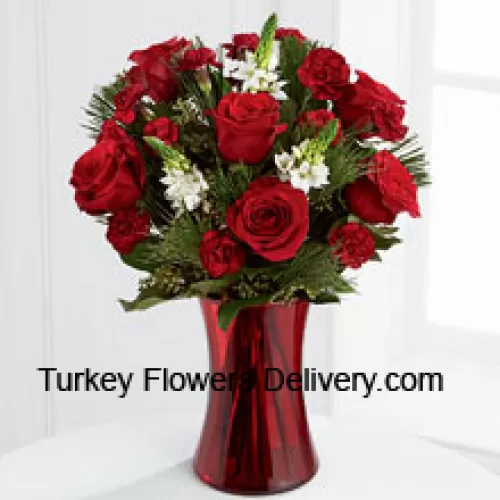 This romantic arrangement bristles with the passion and wonder of the Christmas season. Rich red roses and burgundy mini carnations accented with the snowy white blooms of Stars of Bethlehem, pine branches, and lush greens will easily sweep them off their feet. Arranged in a ruby red clear glass vase, this bouquet conveys your most heartfelt holiday wishes. (Please Note That We Reserve The Right To Substitute Any Product With A Suitable Product Of Equal Value In Case Of Non-Availability Of A Certain Product)