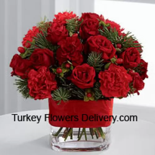 This Bouquet is a cheerful expression of all the merry moments this holiday season has to offer. Bright red spray roses, red mini carnations, burgundy mini carnations, red hypericum berries and assorted holiday greens are elegantly arranged in a clear glass vase bedecked with a rich red ribbon to create a holiday greeting in the spirit of this wondrous season of giving and gratitude. (Please Note That We Reserve The Right To Substitute Any Product With A Suitable Product Of Equal Value In Case Of Non-Availability Of A Certain Product)