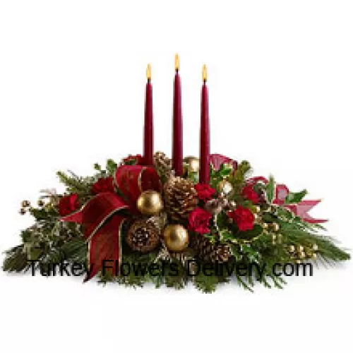 Red miniature carnations, pinecones, golden ornament balls, faux berries and assorted fresh evergreens  accented with a wired ribbon are arranged in a low dish with three red taper candles. (Please Note That We Reserve The Right To Substitute Any Product With A Suitable Product Of Equal Value In Case Of Non-Availability Of A Certain Product)